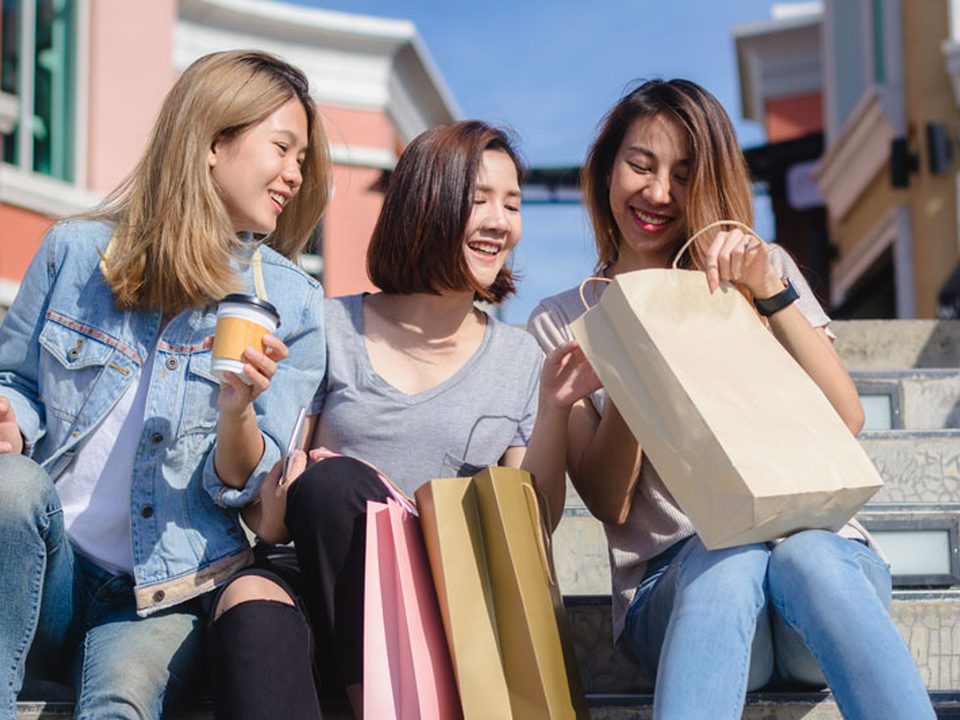 Friends laughing with shopping bags